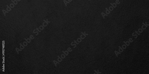Dark charcoal black slate texture with fine grainy grit for industrial background or vintage overlay design