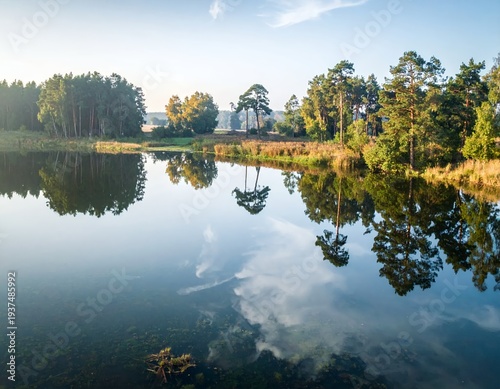 Serene Lake Reflection of Trees and Sky on a Calm Autumn Day.