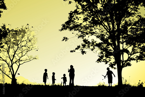 Silhouetted family walking with a kite under a tree at sunset