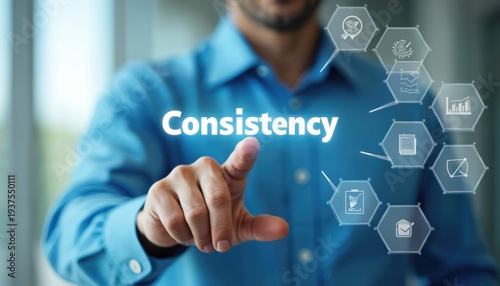 Man in blue shirt interacts with glowing Consistency text and icons. Business strategy involves reliable performance, workflow, and organized processes.