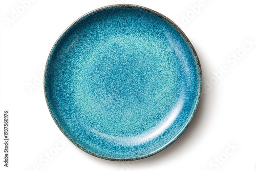 Overhead view of a round textured blue-green ceramic plate with a dark rim on a white background