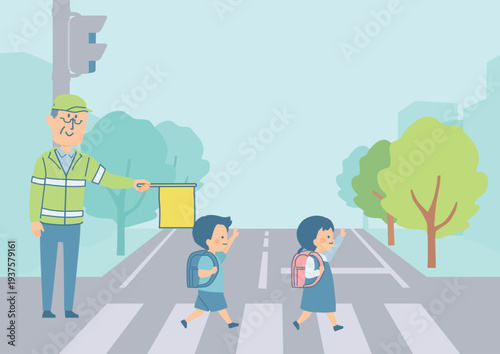 横断歩道を渡る小学生と町の背景