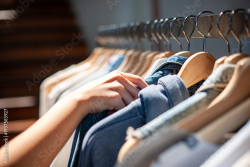 Tableau sur toile Hand selecting clothes on hangers