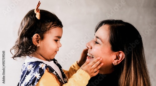 Fotografie Happy latina mother have fun with daughter - Tender family moment and love conce