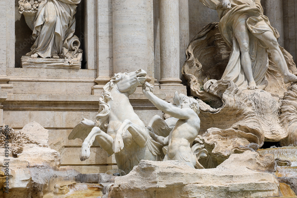 Naklejka premium Closeup view of the statue of the Triton struggling to control a restless winged sea-horse (hippocampus) at the famous Trevi Fountain in Rome, Italy.