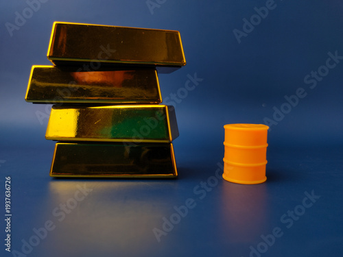 Stack of gold bar with yellow oil barrel on a blue background