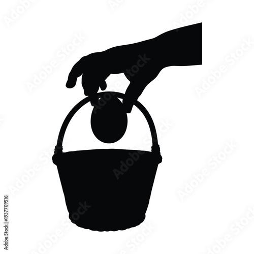 Hand placing ball into bucket in black silhouette on white