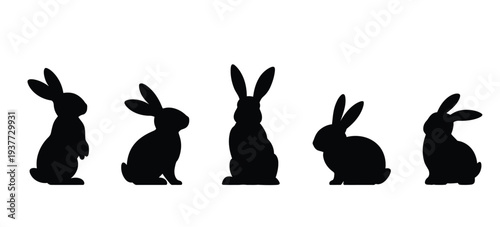 Five black silhouette rabbits in different sitting positions
