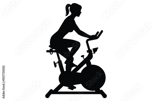 Silhouette of a woman exercising on a stationary bike