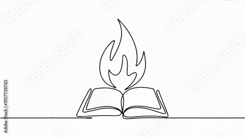 Open book with flame emerging from pages on a desk symbolizing knowledge and inspiration