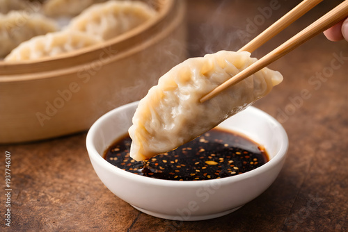 Steamed dumpling dipped in soy sauce with chopsticks, Asian cuisine food concept
