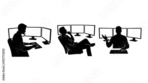 Silhouettes of people working on computers with multiple monitors