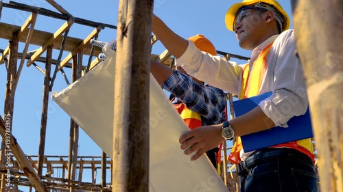 Structural engineer, architect and foreman worker with blueprints discuss, plan working for the outdoors building construction site. Construction collaboration concept. 4K