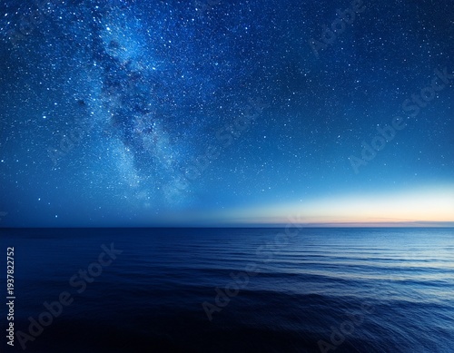 starry night sky in blue hues above a serene ocean seascape with ample copy space image