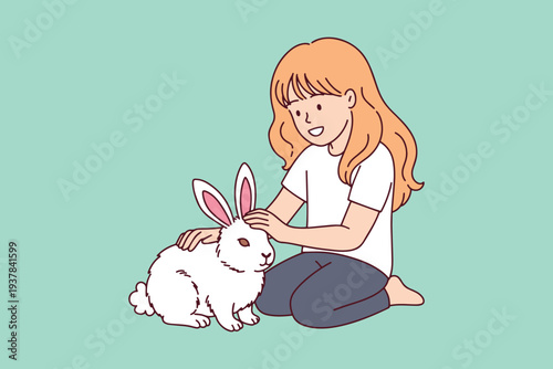 Happy little girl playing with a real white rabbit in the garden during easter spring holiday to experience nature and bond with a cute pet animal