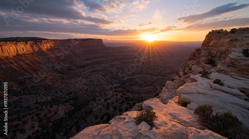 A breathtaking sunset illuminates dramatic cliffs and valleys under a colorful sky