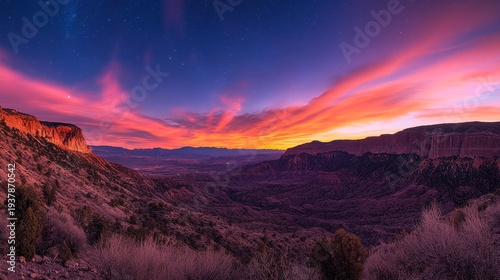 A breathtaking panoramic view of a vibrant sunset over a majestic canyon landscape