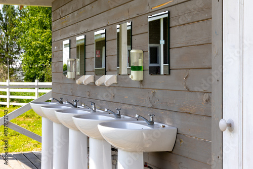 Row of hand sinks in public toilet and washbasins in the campsite