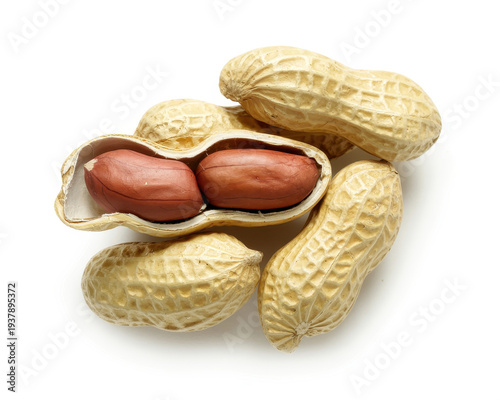 Peanuts in shells with some cracked open peanut shells