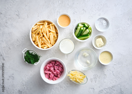 Wallpaper Mural Ingredients are arranged on a table for cooking a meal with vegetables, pasta, meat, and sauces Torontodigital.ca