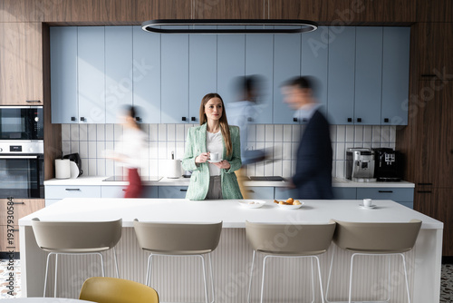 Bild auf Leinwand Businesswoman enjoying coffee break in busy office kitchen
