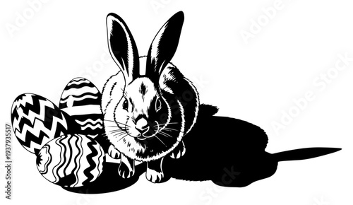 Adorable Easter bunny sitting next to a pile of decorated eggs in black and white