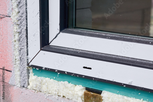 Foto Installation of metal plastic window in a brick wall
