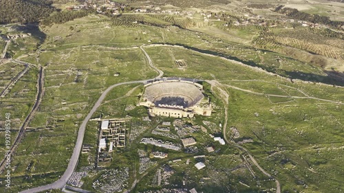 Cinematic aerial drone video of Hierapolis Antik Kenti and Pamukkale travertines in Denizli, Turkey, showcasing the Roman theater, columns, ruins, and dramatic landscape from above.