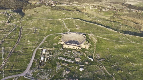 Cinematic aerial drone video of Hierapolis Antik Kenti and Pamukkale travertines in Denizli, Turkey, showcasing the Roman theater, columns, ruins, and dramatic landscape from above.