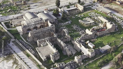 Cinematic aerial drone video of Hierapolis Antik Kenti and Pamukkale travertines in Denizli, Turkey, showcasing the Roman theater, columns, ruins, and dramatic landscape from above.