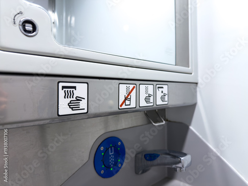 Public hygiene station with clear symbols indicating hand washing and restricted drinking, promoting sanitation, water conservation, and universal accessibility for all users