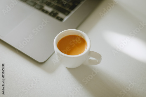 cup of coffee on a table with laptop morning work 