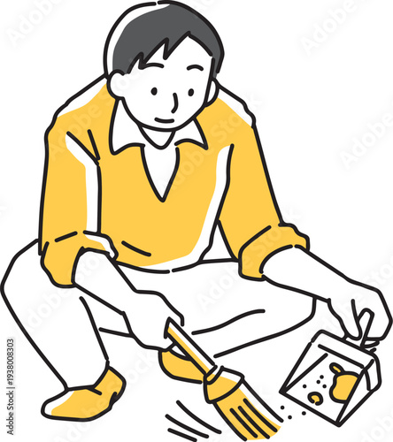 箒とちりとりで埃を集める男性