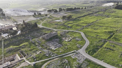 Cinematic aerial drone video of Hierapolis Antik Kenti and Pamukkale travertines in Denizli, Turkey, showcasing the Roman theater, columns, ruins, and dramatic landscape from above.