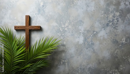 A wooden cross with a palm tree in front of a gray stone wall for Christian worship and Palm Sunday