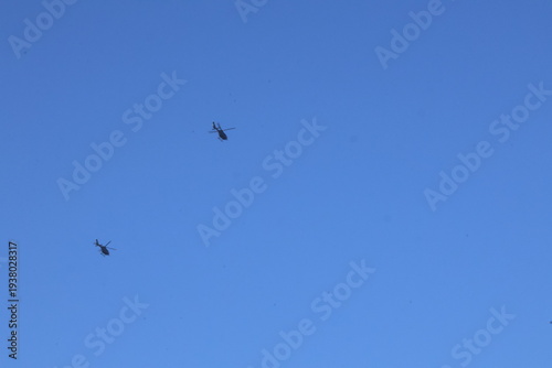 Wallpaper Mural Two military helicopters flying in clear blue sky during aerial operation Torontodigital.ca