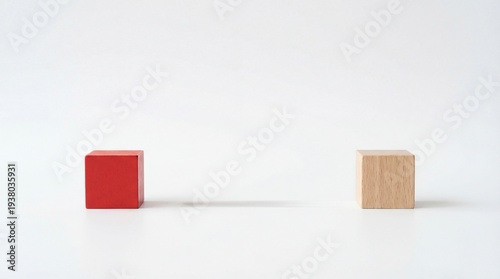 Two wooden cube with different colors isolated. One red and one natural, arranged separately, a conceptual image of contrast and balance
