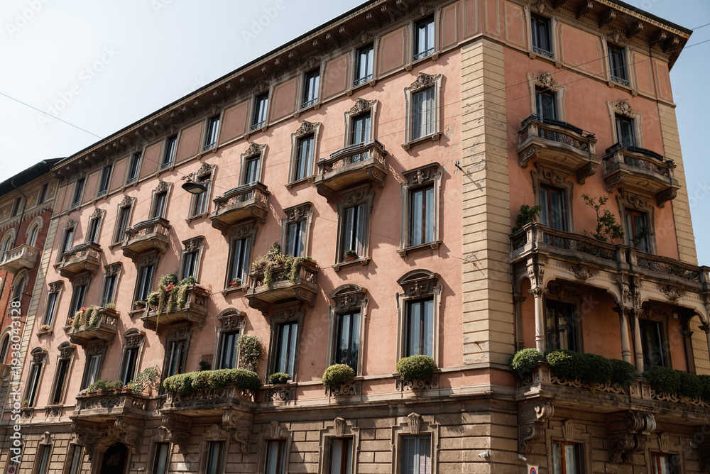 Fototapeta premium historical buildings in milan in italy. Beautiful architecture, the atmosphere of the old town, cozy balconies with flowers.