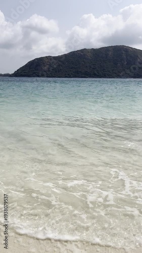 Gentle waves lapping on serene beach tropical island nature photography bright daylight wide angle tranquility