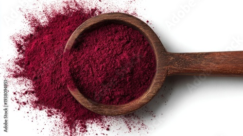 A wooden spoon filled with beet root powder isolated on white background