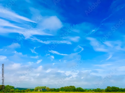 Canvas Print Bright blue skies stretch over rolling green hills inviting joyful exploration a