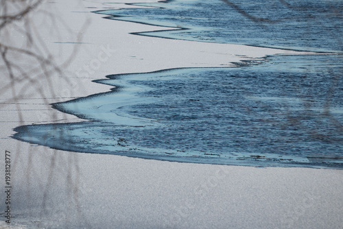 Abstract ice patterns on frozen river in Kyiv Ukraine winter background