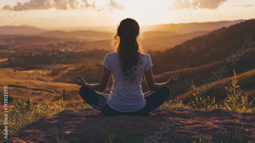 woman meditating on the mountains on the sunrise