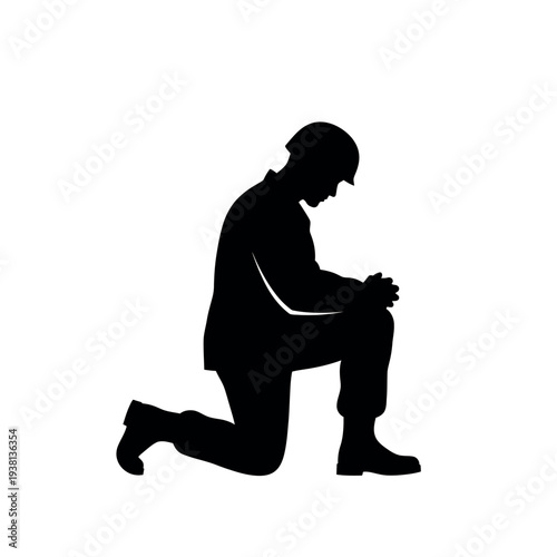 Silhouette of a soldier kneeling in solemn reflection.