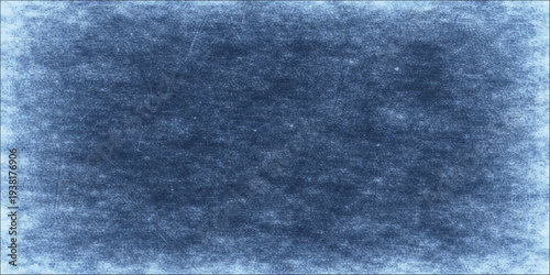 Dark blue vintage grunge background with a rough abstract paper texture and a dark blue denim fabric material pattern on a blank weathered wall surface
