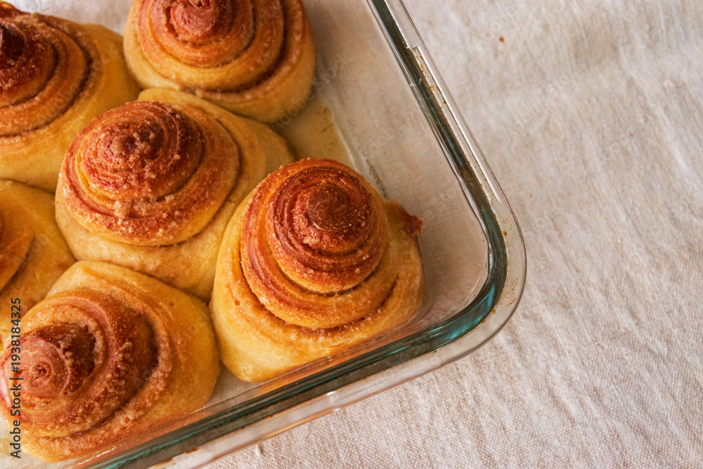 Fototapeta premium Sourdough cinnamon rolls in a glass baking pan