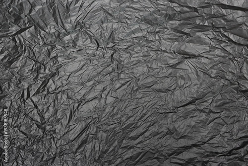 Wrinkled black plastic sheet pattern background