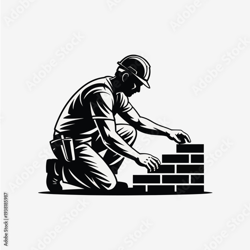 Construction worker building brick wall with hard hat and tool belt focused on laying bricks