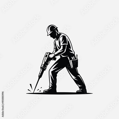 Construction worker using a jackhammer on a solid surface with safety gear and tool belt