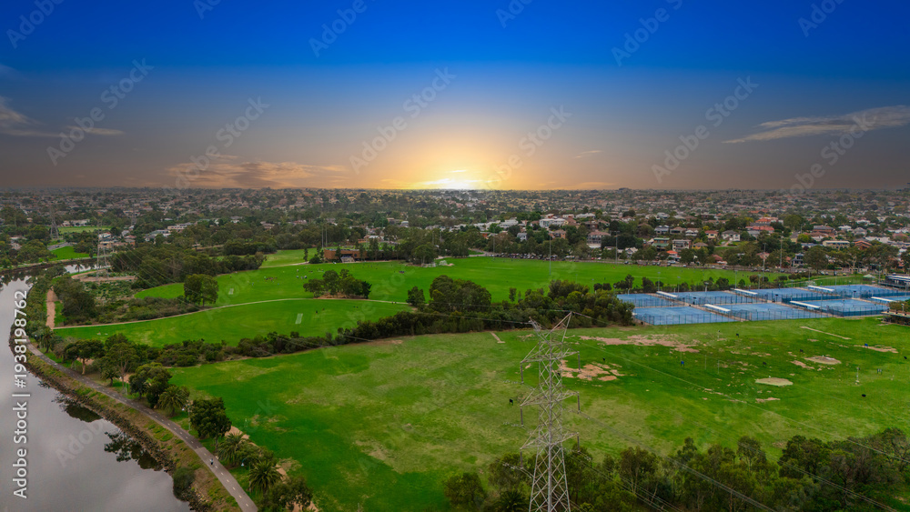 Fototapeta premium Panoramic Aerial Drone view of Inner Suburbs of Melbourne housing, roof tops, the streets and the parks, the roads and trees of Ascot Vale Moonee Ponds Brunswick Essendon and Maribyrnong in VIC Victor